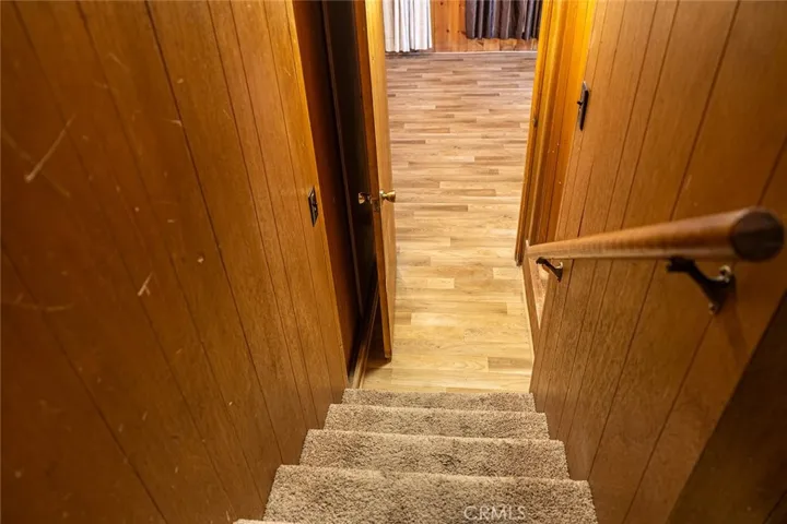 At the bottom of the stairs to left is the door for Heating unit, the right side is a closet.