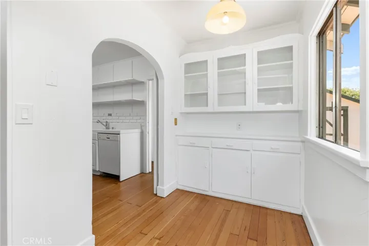 Dining area with storage with view towards kitchen.