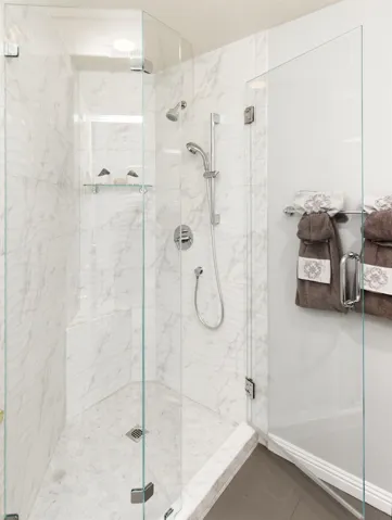 Full bath featuring a marble finish shower