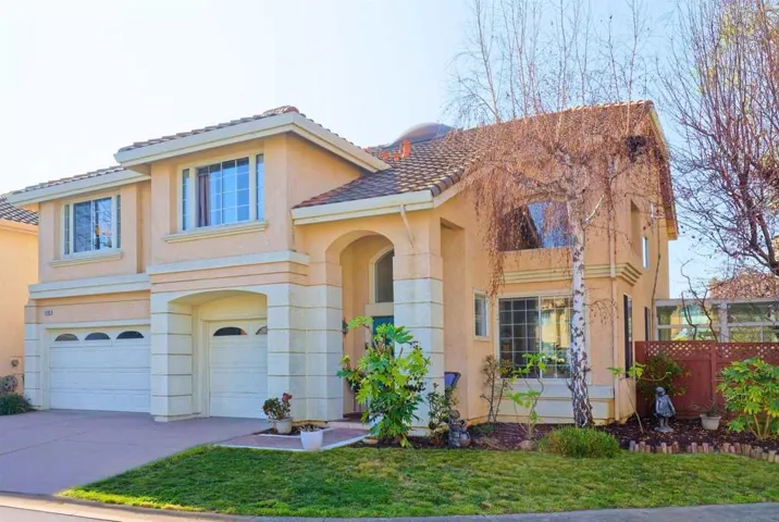 Mediterranean / spanish-style house featuring an attached garage, concrete driveway, stucco siding, and a tile roof