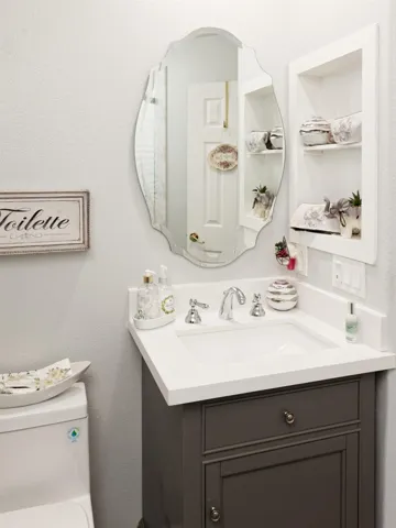 Bathroom with a textured wall and vanity