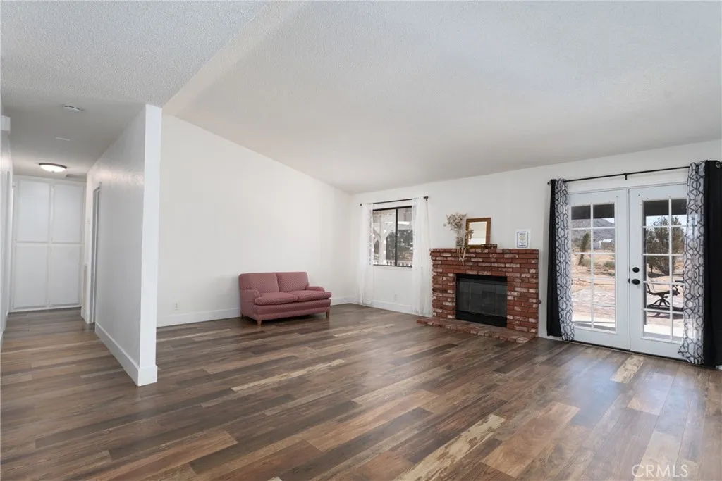 View of open living room and hallway to bedrooms