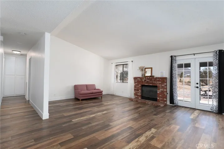 View of open living room and hallway to bedrooms