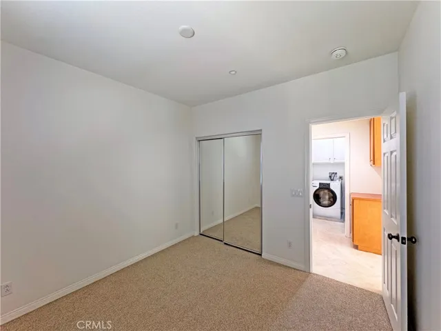 Another view of the downstairs bedroom showing mirrored closet doors