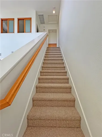 Staircase to main bedroom and bath