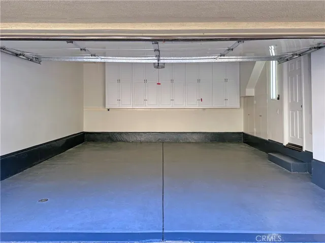Spacious garage with great built-in cabinetry