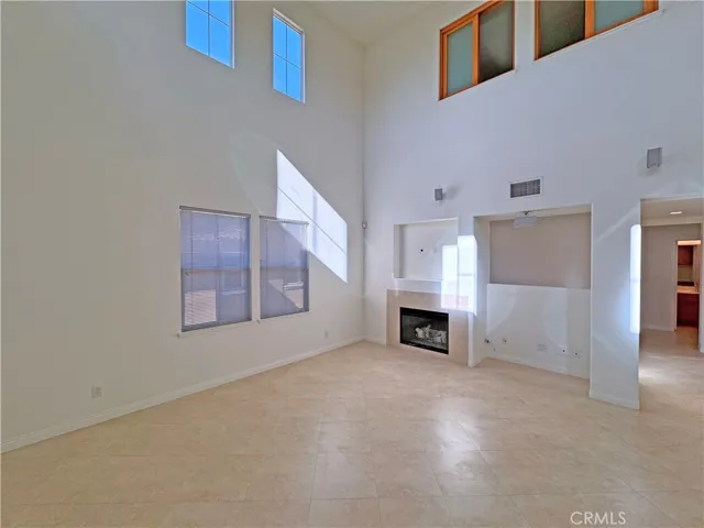 Another angle of the great room showing the fireplace and niche for TV and sound equipment