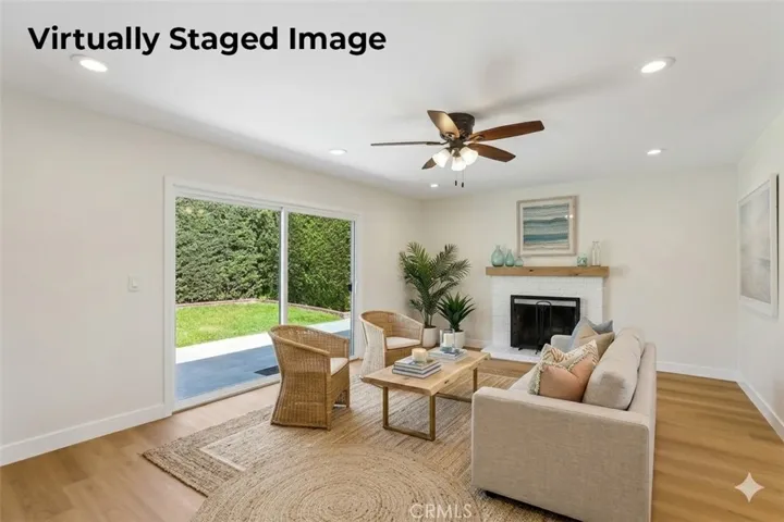 Living room looking toward the back yard virtually staged
