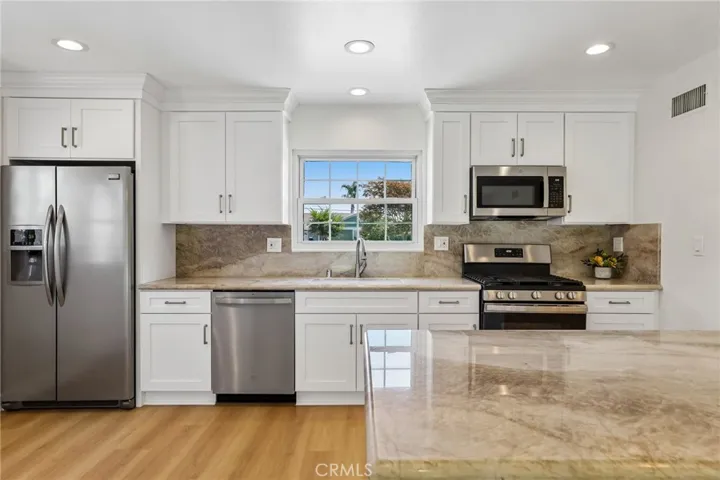 Kitchen and island that can seat four people (3 on one side and 1 person on the end)