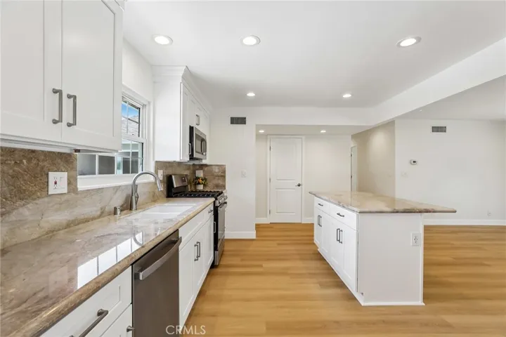Kitchen and island that can seat four people (3 on one side and 1 person on the end)