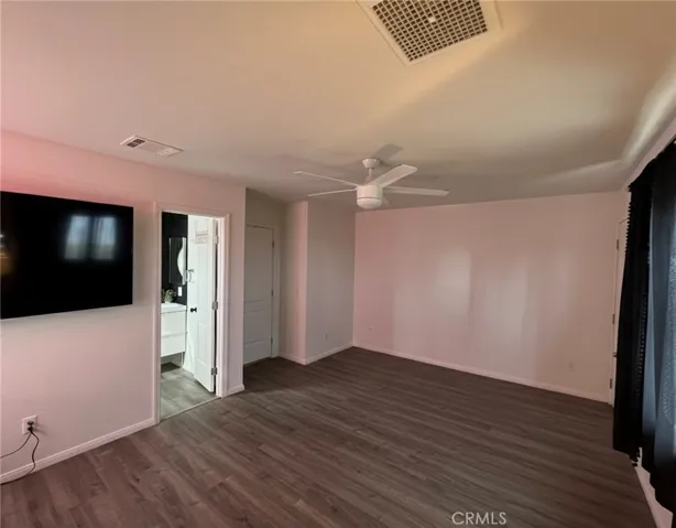 Primary suite with en-suite bathroom and private entrance. Image edited using AI to remove furniture for clarity.