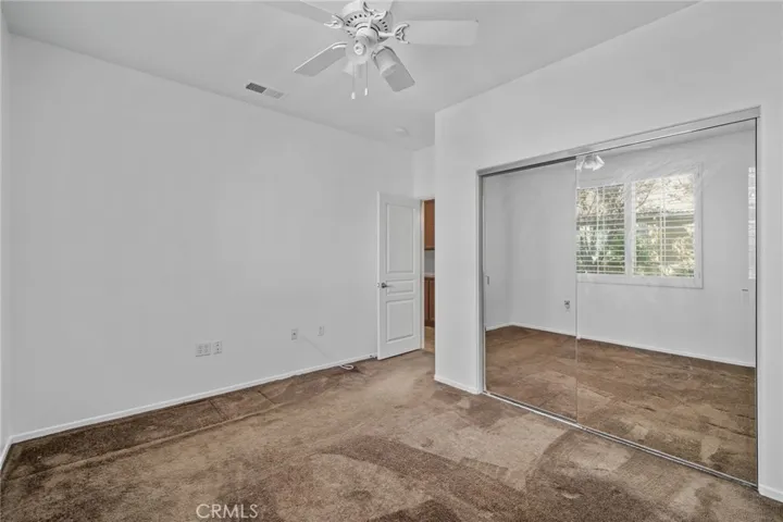 2nd Bedroom showing mirrored closet