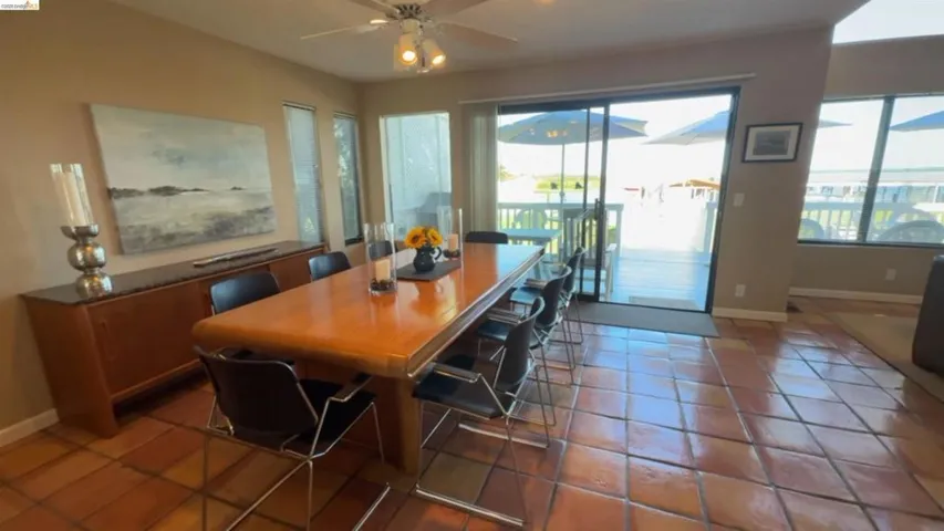 Dining space with plenty of natural light and light tile patterned flooring