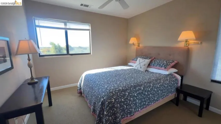 Bedroom featuring a ceiling fan and carpet floors