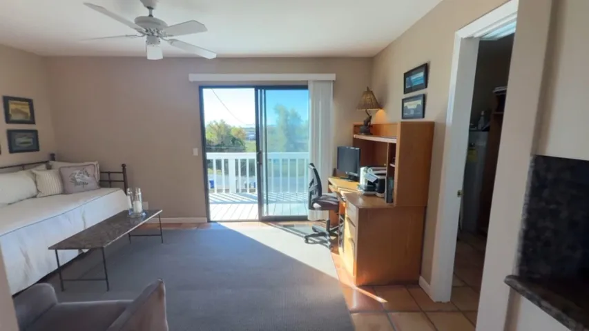Office space featuring ceiling fan and baseboards