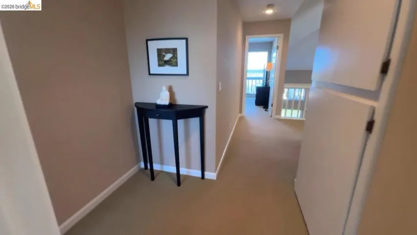 Hall with baseboards and carpet flooring