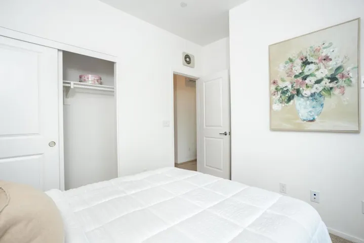 Bright secondary bedroom with closet space and natural light.
