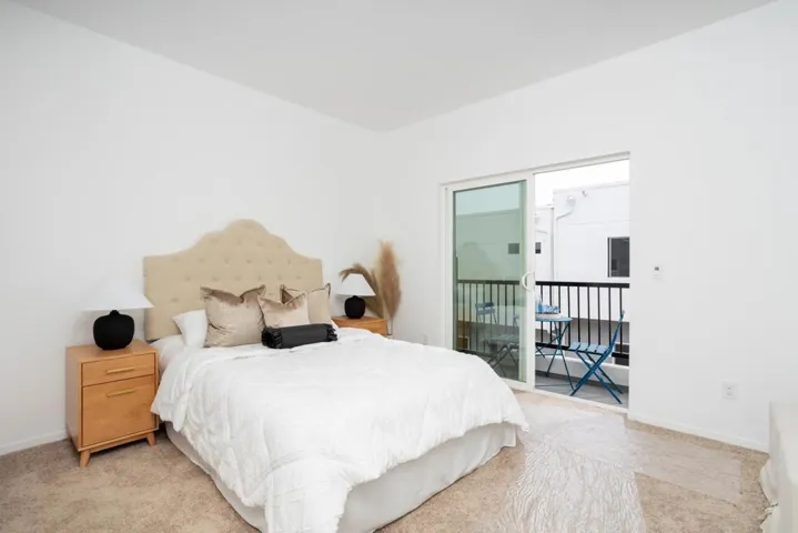 Spacious primary suite with abundant natural light and private balcony access.