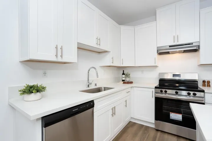 White cabinets with stainless steel applicances.