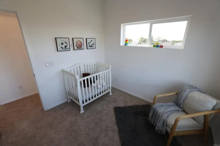Secondary bedroom with nearby open nook ideal for study or play area.
