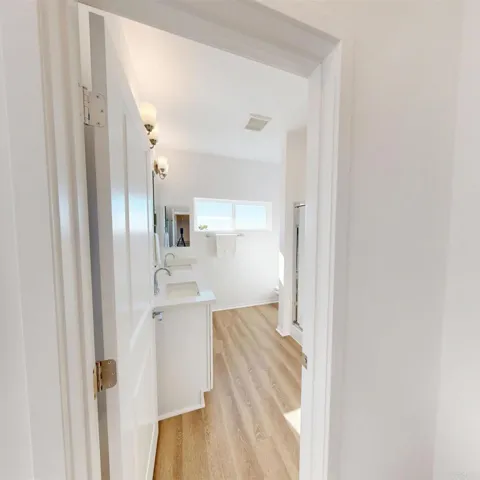 Modern bathroom with sleek double sink vanity and updated fixtures.