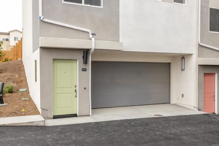 New construction exterior with attached garages in a detached PUD community.