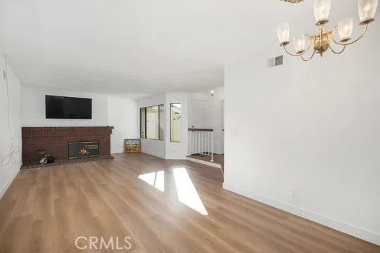 (PHOTO ENHANCED to add Fireplace flame) Open spacious Great room, with fireplace and TV