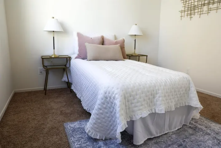 Bedroom with neutral finishes and natural light.