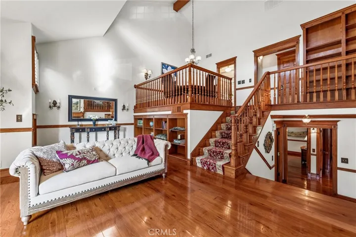 Living room has hickory floor and elegant fireplace. Mezzanine overlooks living room.