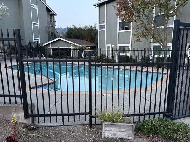 Community pool featuring a patio