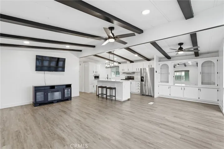 Living room. Great room. Ceiling fan. Beams.