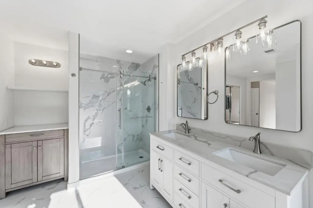 Primary Bathroom with dual vanities and standing shower