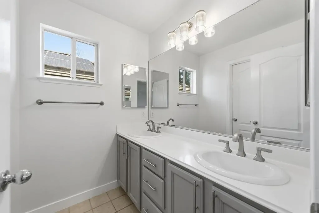 Shared Bathroom with dual vanities, tub and shower