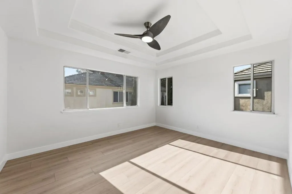 Primary Bedroom with soffits and ceiling fan