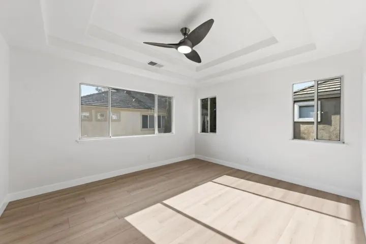 Primary Bedroom with soffits and ceiling fan