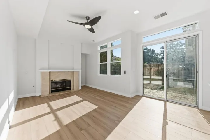 Family room with gas fireplace and ceiling fan
