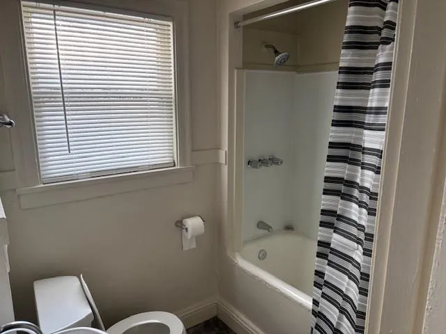 Full bathroom featuring shower / tub combo with curtain and plenty of natural light