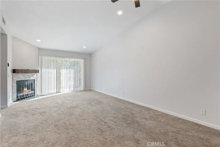 large living area with fireplace and lots of sun