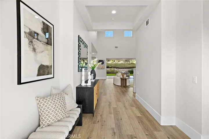 Grand foyer opening to dramatic high-ceiling great room
