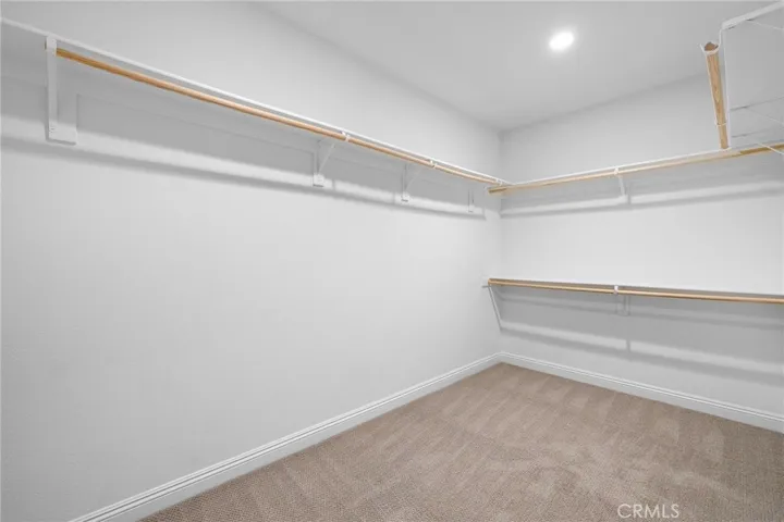 Spacious oversized walk-in closet in the primary suite
