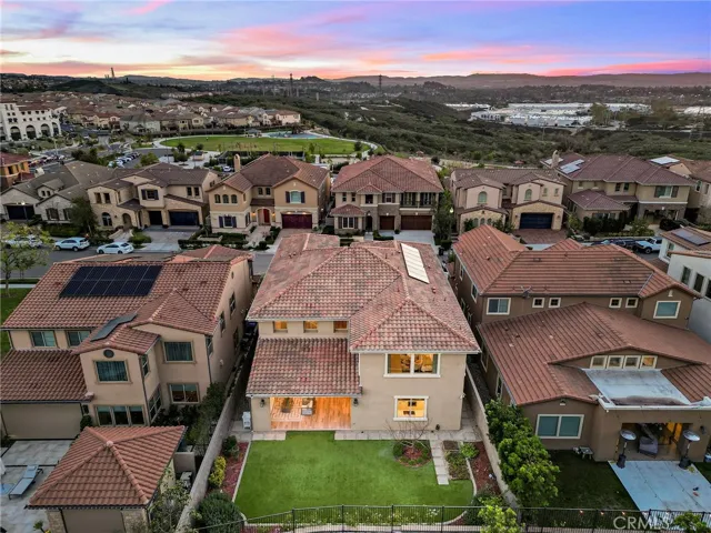 Sunset drone shot showcasing the home and surrounding community
