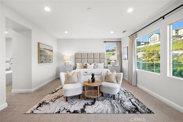 Expansive primary bedroom with abundant natural light
