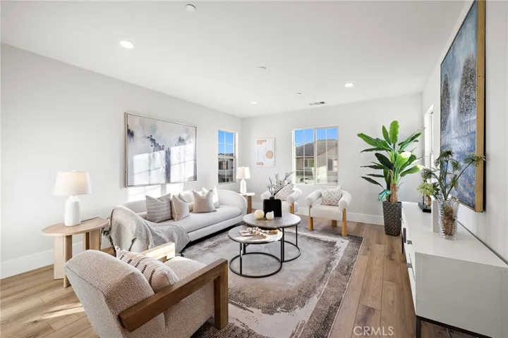Airy upper-level family room surrounded by windows and natural light
