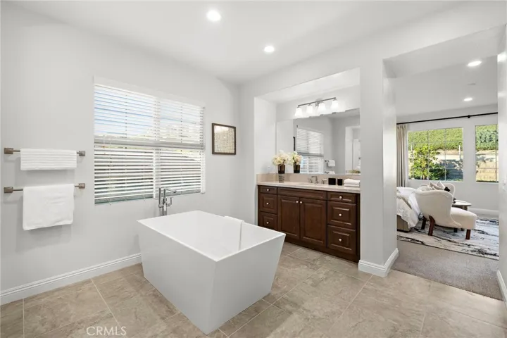 Primary bathroom with dual vanities, soaking tub, and oversized shower with dual shower heads
