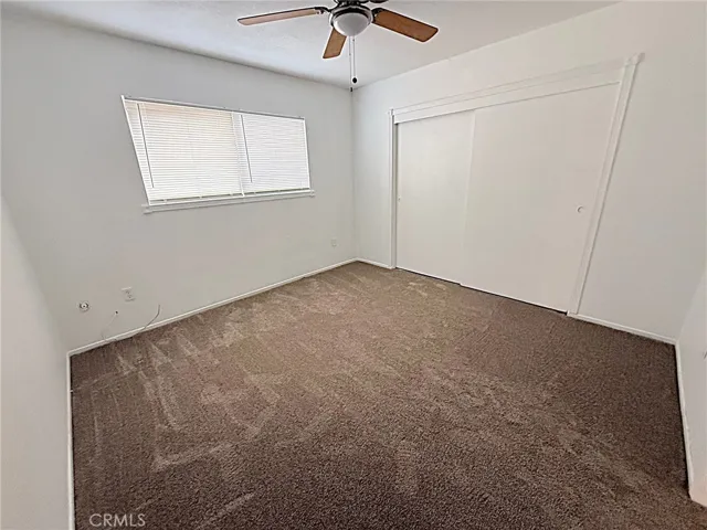 Bedroom Three has new carpet and ceiling fan with good closet space.