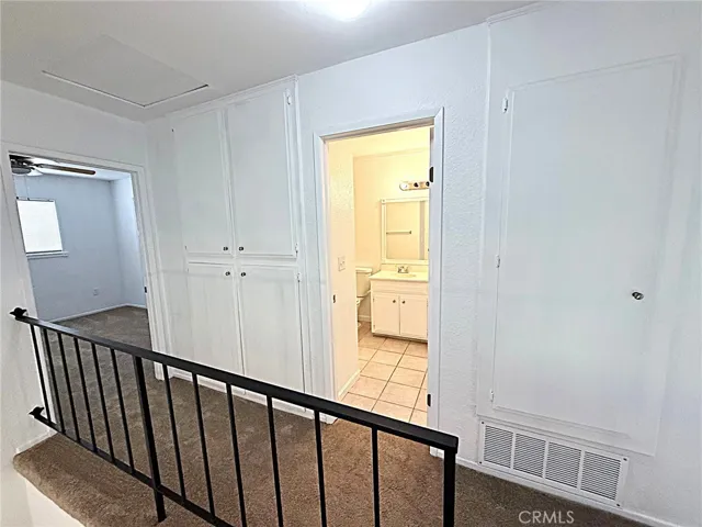 Hallway showing bathroom two upstairs.