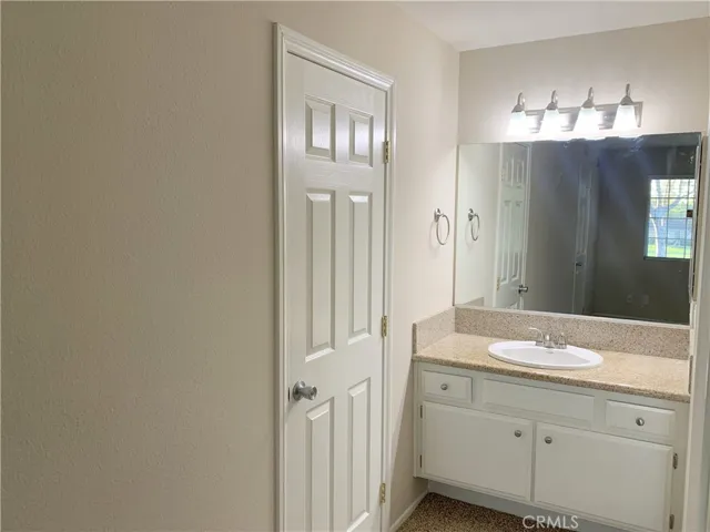 Convenience of sink and vanity in primary bedroom