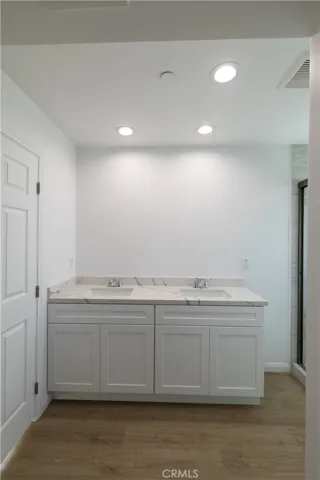 Dual sinks in primary bathroom suite. Mirrors will be installed prior to move-in.