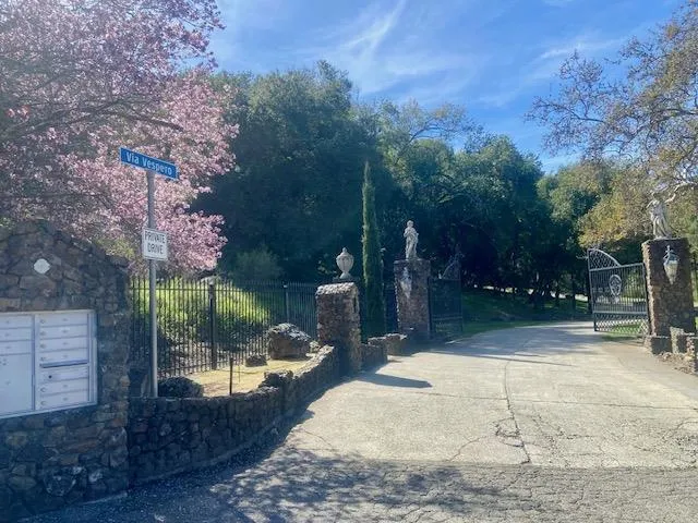 Enter through this gate with the street name sign Via Vespero.