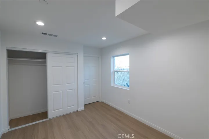 Bedroom with closet and door leading to its own bathroom.